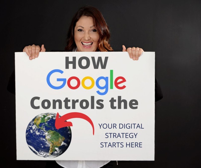 Elizabeth Orley holding a sign that says "How Google Controls the World Your Digital Strategy Starts Here."